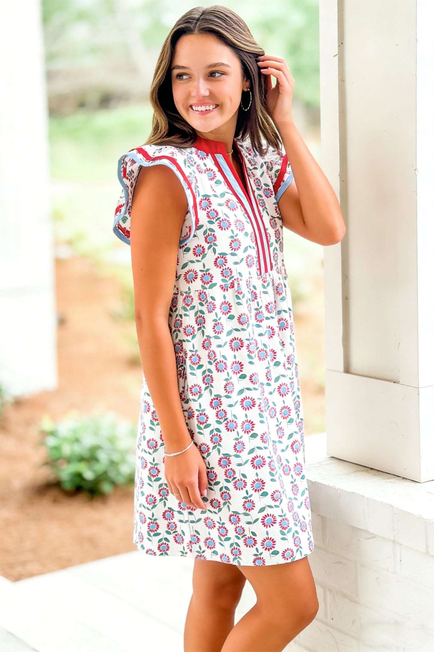Red floral print flutter sleeve mini dress with contrast trim, worn by a smiling model.