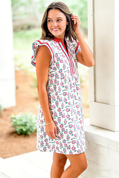 Red floral print flutter sleeve mini dress with contrast trim, worn by a smiling model.