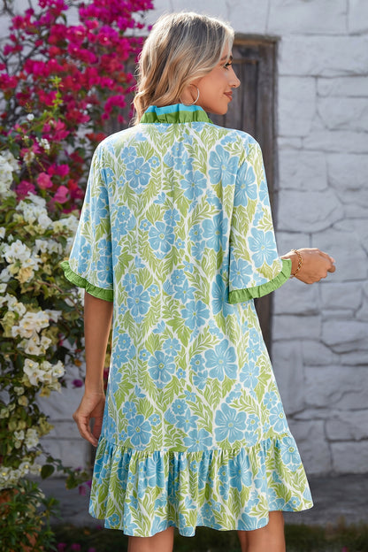 Model in green floral dress with blue flowers and green trim sleeves; size chart shows US 4-6 to 12-14.